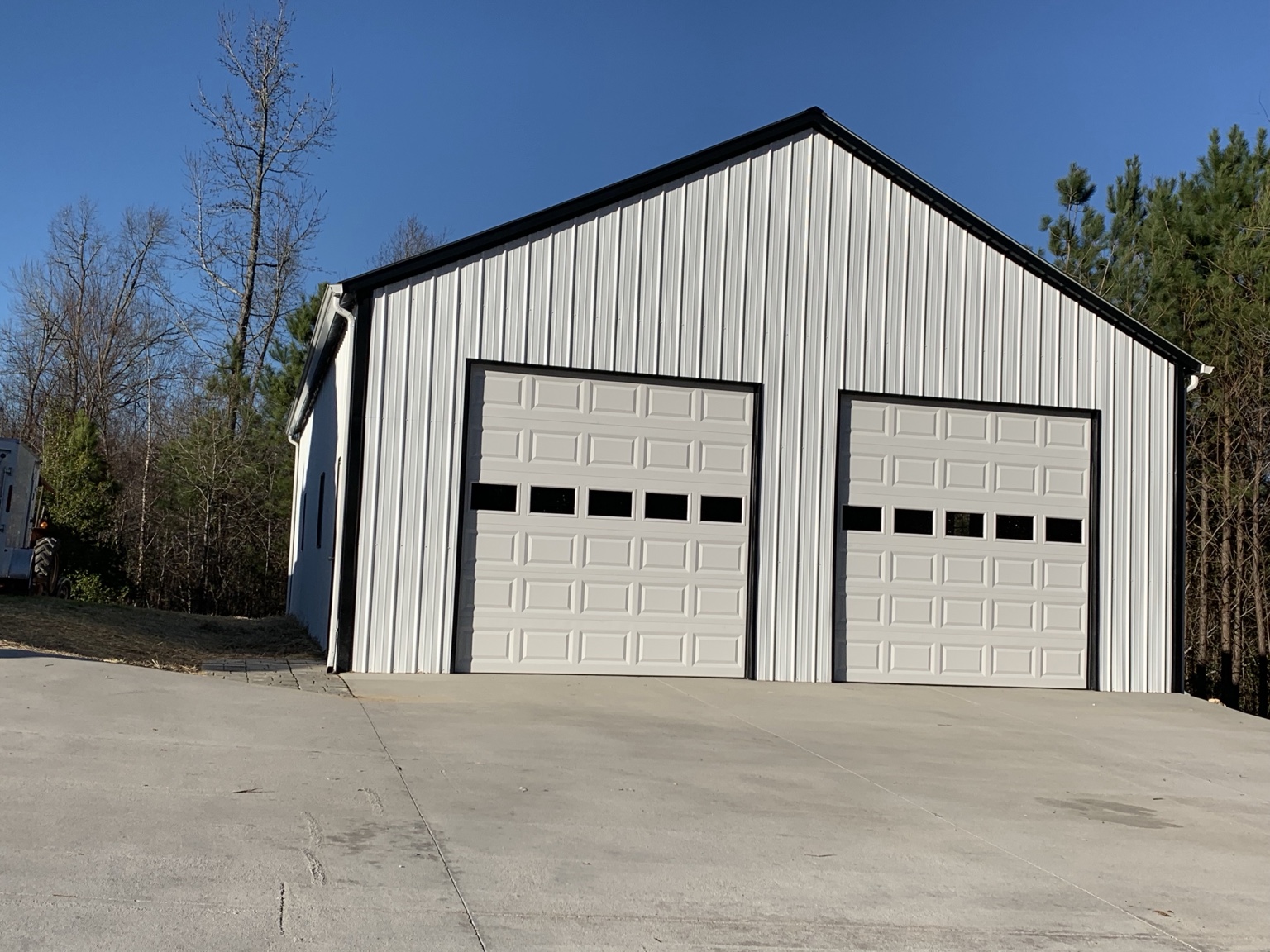 White two-door garage with black trim