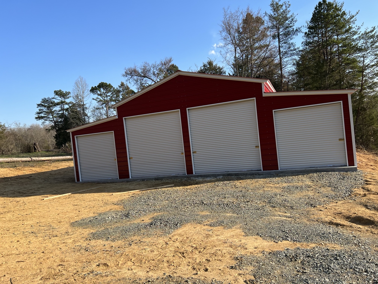 Red four-door garage with stepped roofline