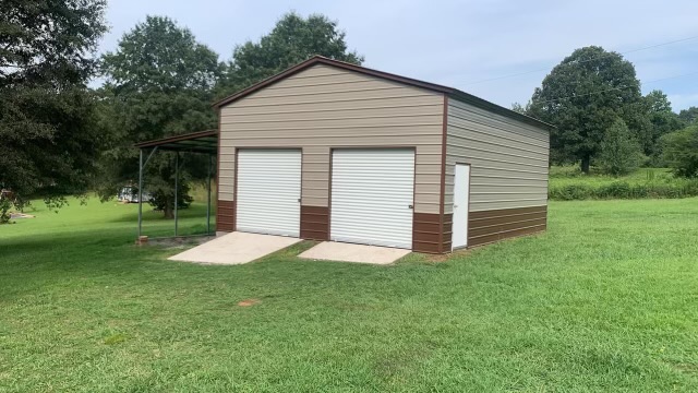 Tan two-door garage with a side shelter