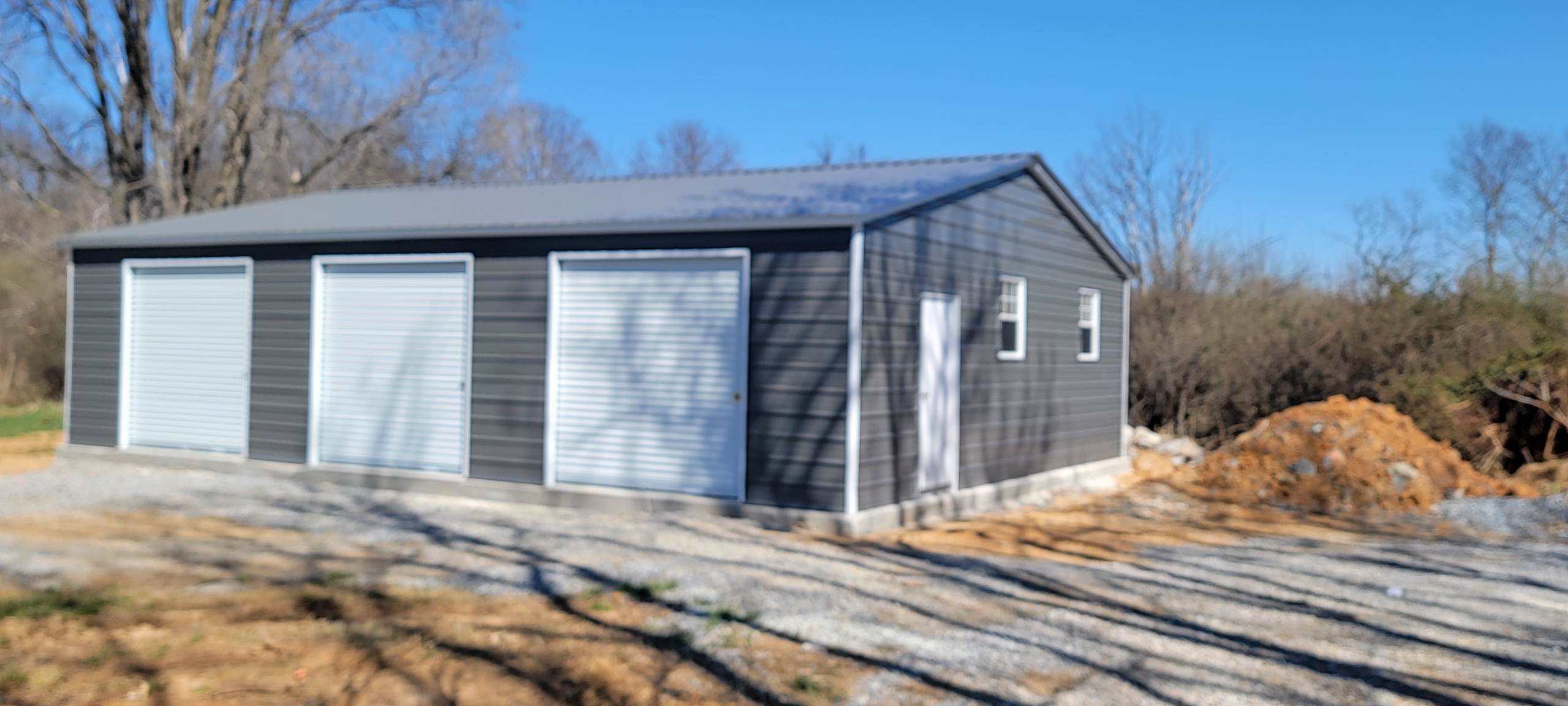 Charcoal three-door garage with white trim